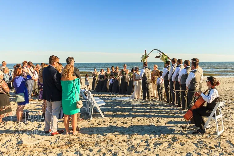 String ensemble performing at a beach wedding ceremony